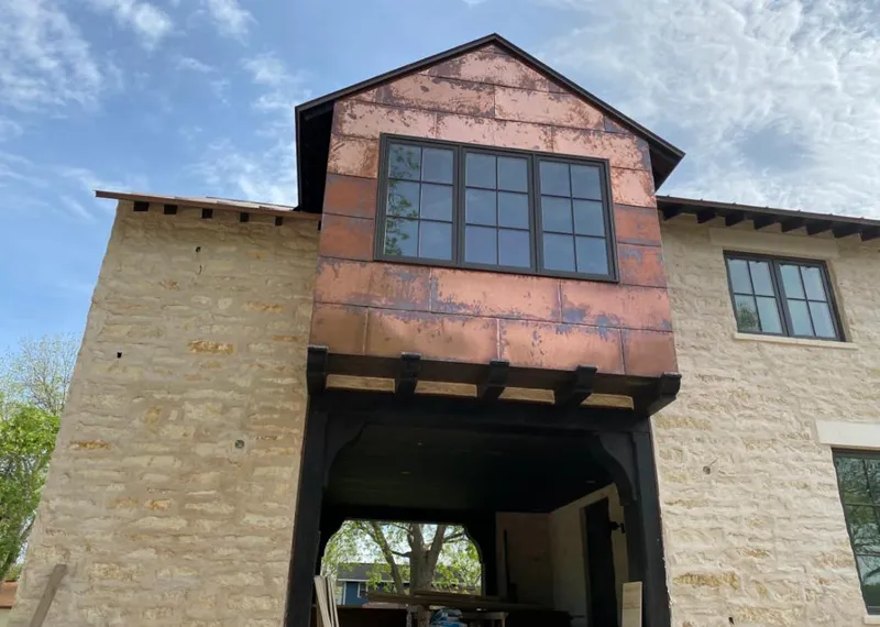 Copper metal panel facade on a stone building for Metal Roof Coating in Scott