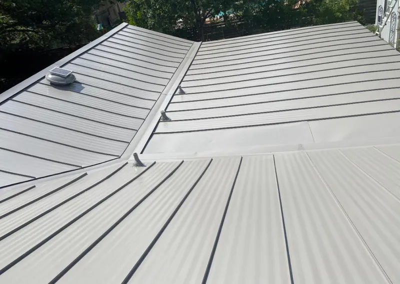 Solar attic fan installed on a metal roof for Roof Ventilation in Scott